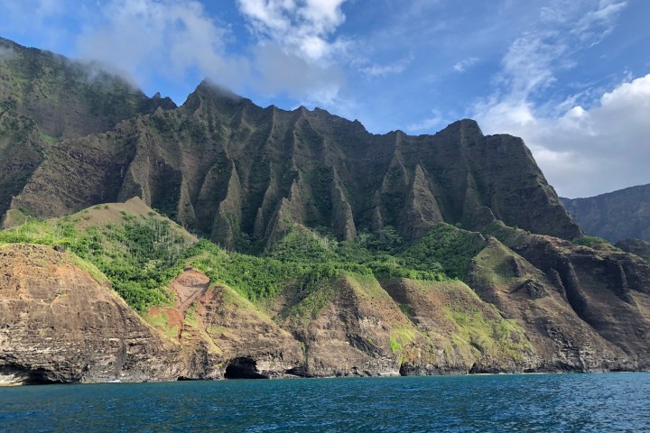 a large body of water with a mountain in the background